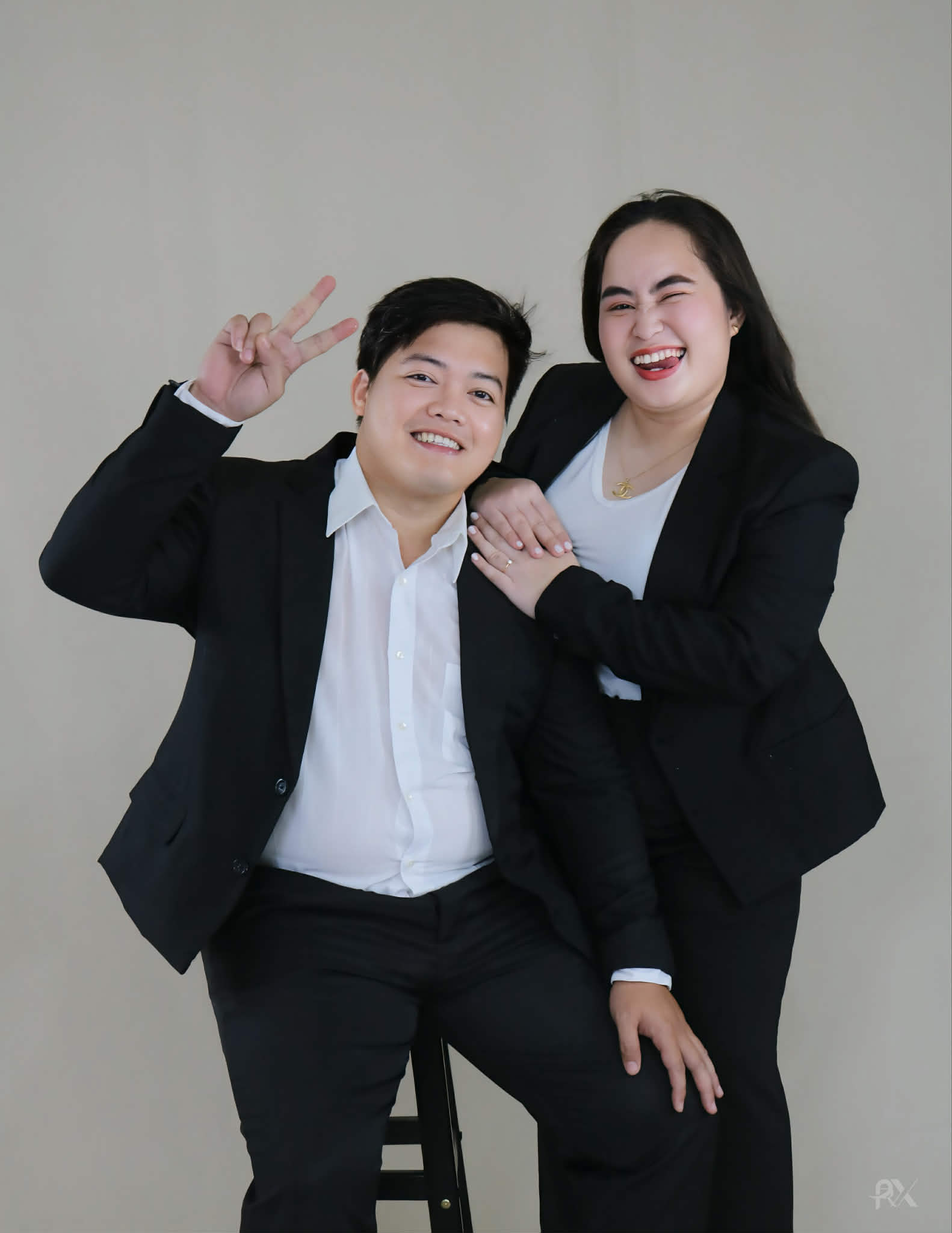 Ryan and Margorie sharing a joyful, playful moment in their studio portrait